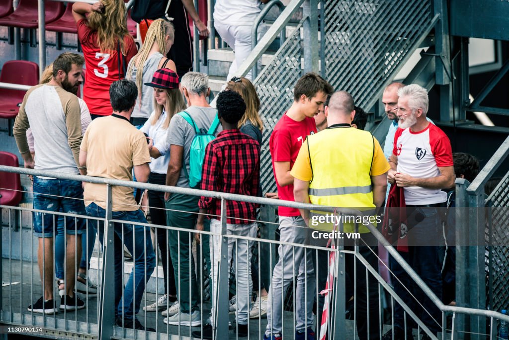 Sports fans walking onto stadium bleachers