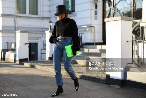 Aylin Koenig wearing Balenciaga shoes, Stradivarius jeans, Orseund Iris sweater, Prada bag on February 18, 2019 in Hamburg, Germany.