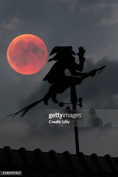 blood moon over the roof of a house with weather vane with weather witch, baden-wuerttemberg, germany - total lunar eclipse over germany stock pictures, royalty-free photos & images