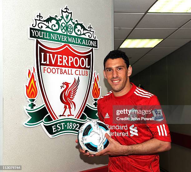 Maxi Rodriguez of Liverpool poses with the hat-trick ball after the Barclays Premier League match between Liverpool and Birmingham City at Anfield on...