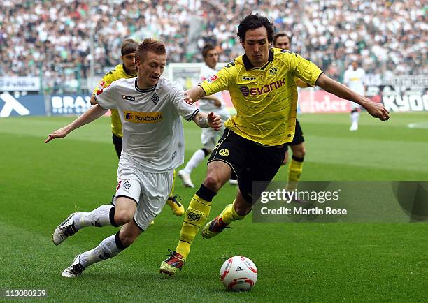 Marco Reus of Gladbach and Mats Hummels of Dortmund battle for the ball during the Bundesliga match between Borussia Moenchengladbach and Borussia...