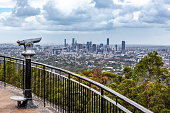Coin-operated binoculars pointed at Brisbane CBD skyline from lookout