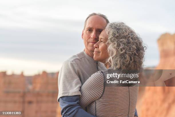 senior couple taking a break from hiking in the utah mountains - asian couple exercise stock pictures, royalty-free photos & images