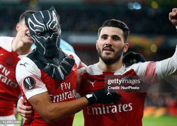 Pierre-Emerick Aubameyang of Arsenal celebrate with a mask and \with Dead Kolasinac of Arsenal during Europa League Round of 16 2nd Leg between...