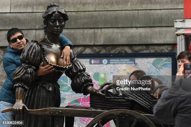Tourist takes a photo with Molly Malone statue on the opening day of St Patrick's Day Festival. On Friday, March 15 in Dublin, Ireland.