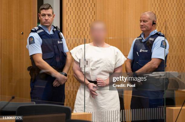 The man charged in relation to the Christchurch massacre, Brenton Tarrant, gestures in the dock for his appearance for murder in the Christchurch...