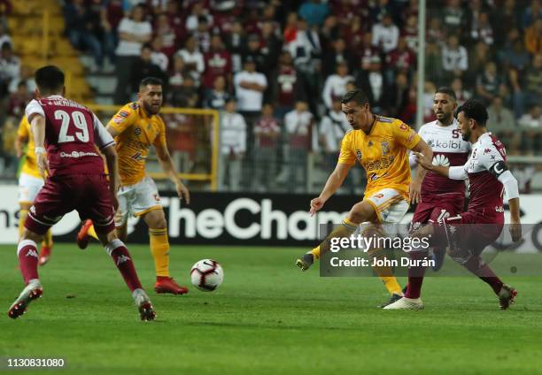Jesús Dueñas of Tigres UANL dominates the ball against the mark of the player Michael Barrantes of Deportivo saprissa, during the first leg of the...