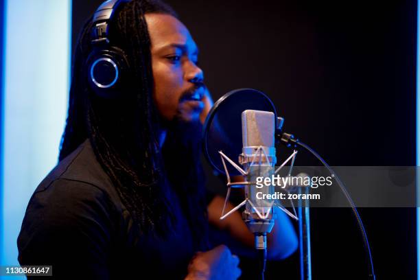 close-up of man singing in recording studio - microphone mouth stock pictures, royalty-free photos & images