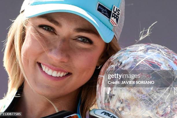 Overall FIS Alpine ski Super G 's winner US Mikaela Shiffrin celebrates as she holds the crystal globe trophy during the podium ceremony after...