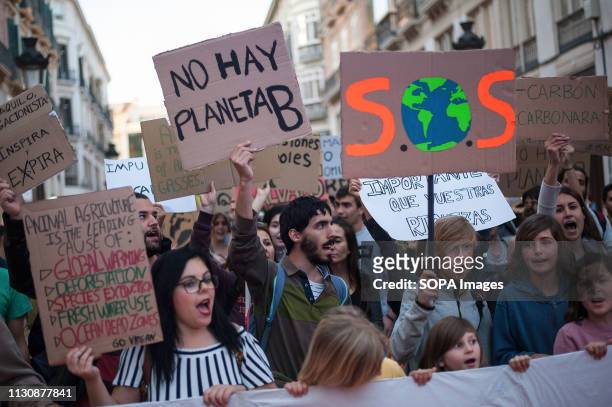 Protesters are seen holding placards and a banner during the demonstration. Under the slogan Climate emergency, thousands of people protest against...