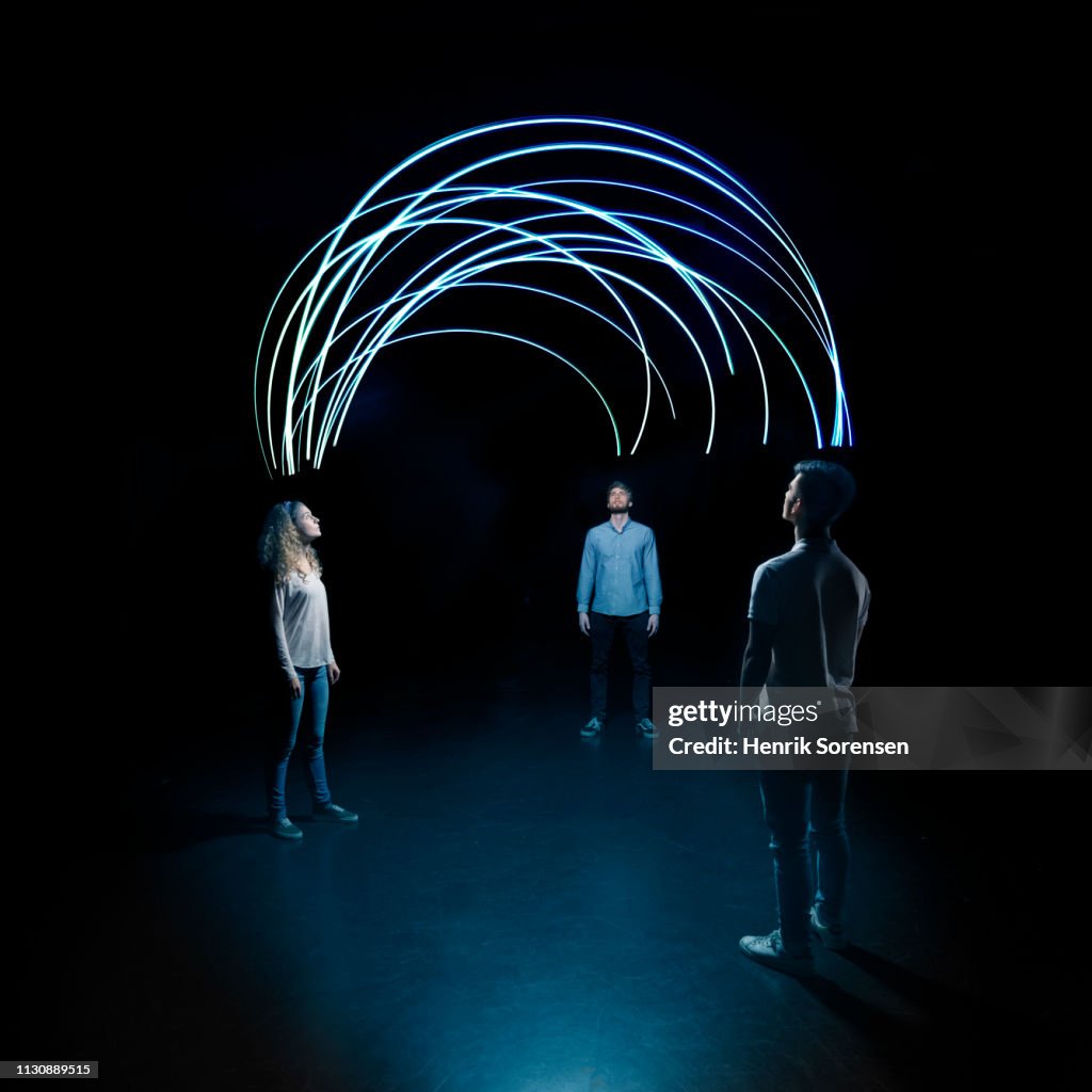 Young people looking up at lighttrace arches