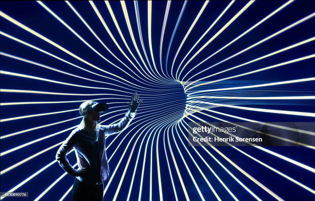 Young woman inside lighttrace tunnel