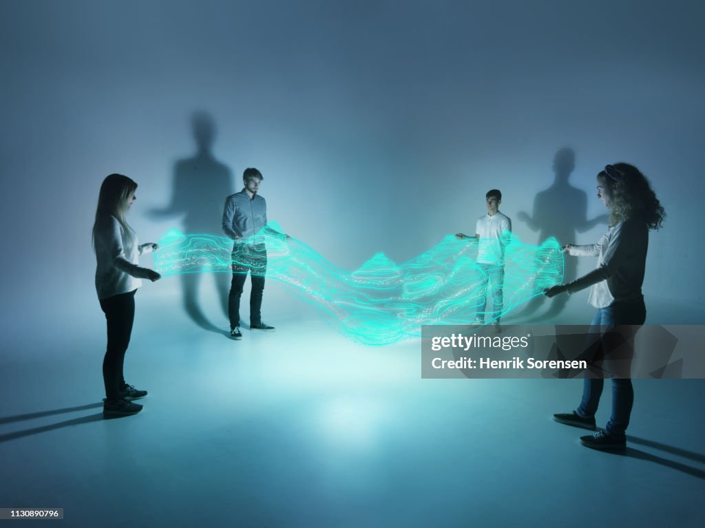 Young people holding a lighttrace carpet