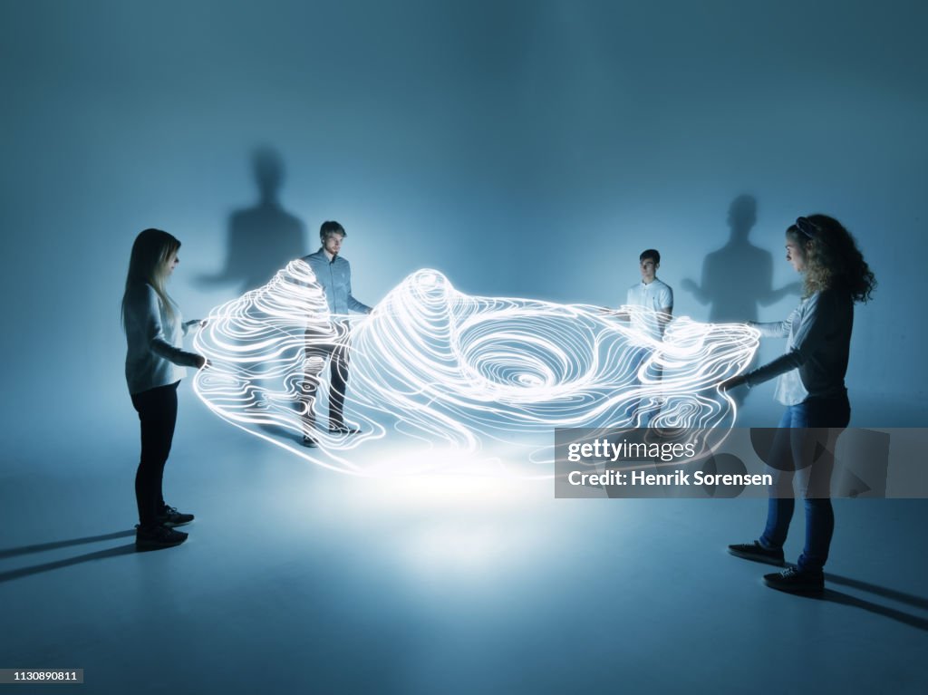 Young people holding a lighttrace carpet