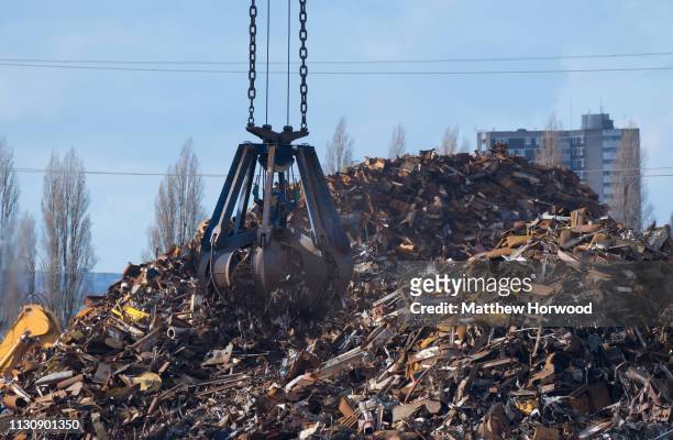 Scrap metal is loaded on to the Strategic Vision ship of Singapore using a mechanical grabber at the Port of Southampton on February 10, 2019 in...