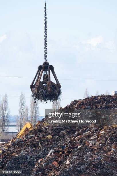 Scrap metal is loaded on to the Strategic Vision ship of Singapore using a mechanical grabber at the Port of Southampton on February 10, 2019 in...