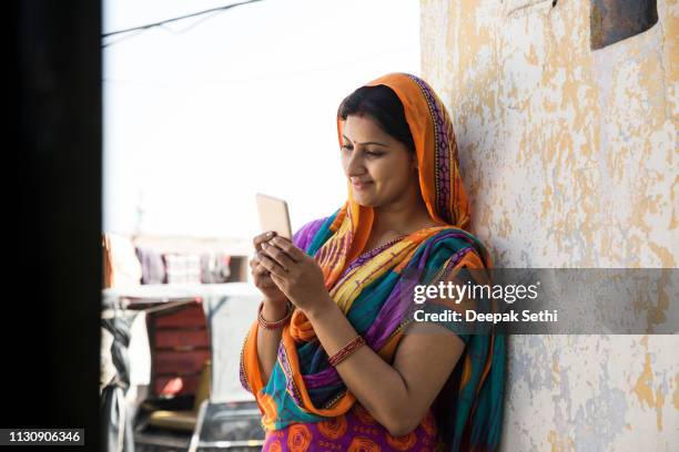 portrait indian woman in sari at village - stock image - rural india stock pictures, royalty-free photos & images