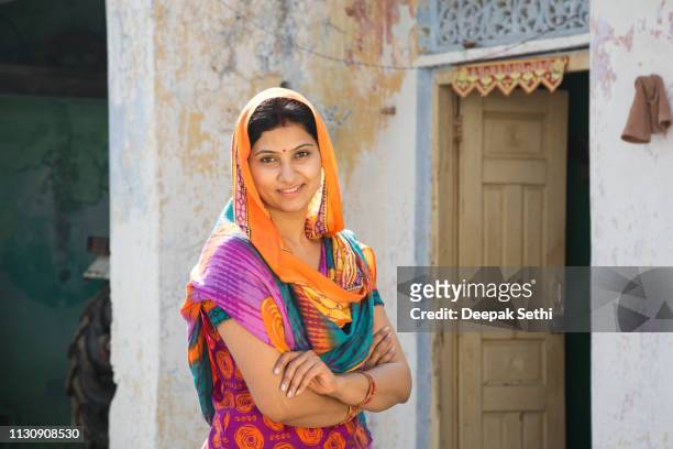 portrait indian woman in sari at village - stock image - village stock pictures, royalty-free photos & images