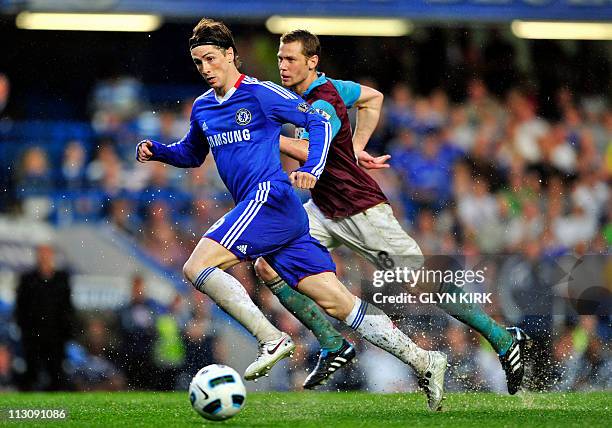 Chelsea's Spanish striker Fernando Torres vies with West Ham's US defender Jonathan Spector during the English Premier League football match between...