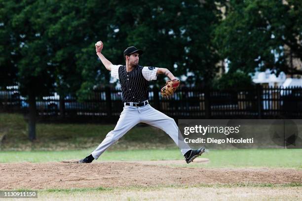 baseball player in throwing stance - baseball pitcher stock-fotos und bilder