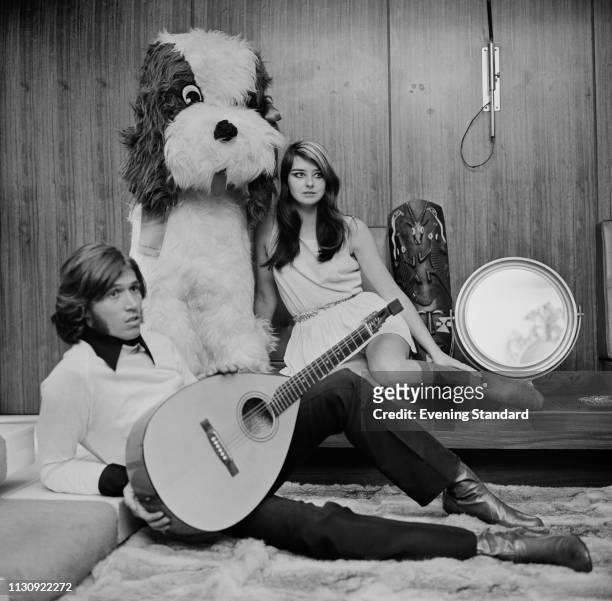 British singer-songwriter and musician Barry Gibb, holding a lute, with his girlfriend Linda Gibb and a giant stuffed dog toy, UK, 25th January 1969.