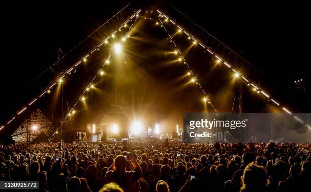 Members of the US rock band the Red Hot Chili Peppers perform during their concert by the Giza Pyramids on the western outskirts of the Egyptian...