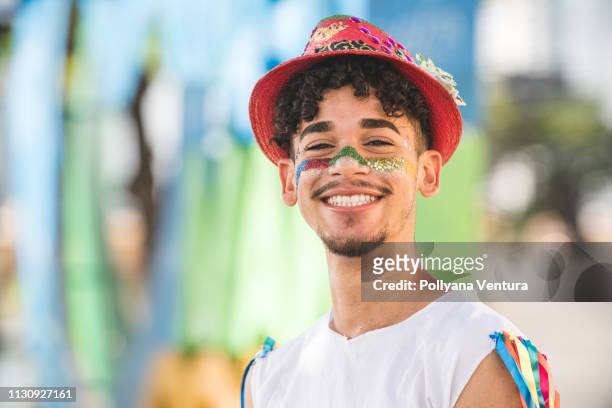 portrait of the young man with carnival costume - fiesta stock pictures, royalty-free photos & images