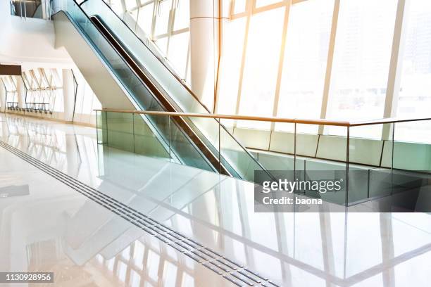 escalator on modern office building - business white background stock pictures, royalty-free photos & images