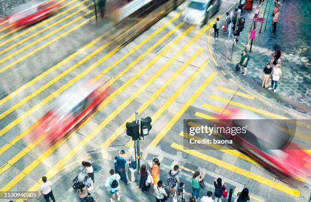 blurred cars driving on city crosswalk - pedestrian stock pictures, royalty-free photos & images