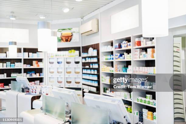a pharmacy counter with medicine on display - farmacista foto e immagini stock