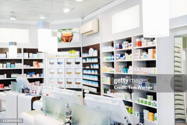 a pharmacy counter with medicine on display - chemist stock pictures, royalty-free photos & images