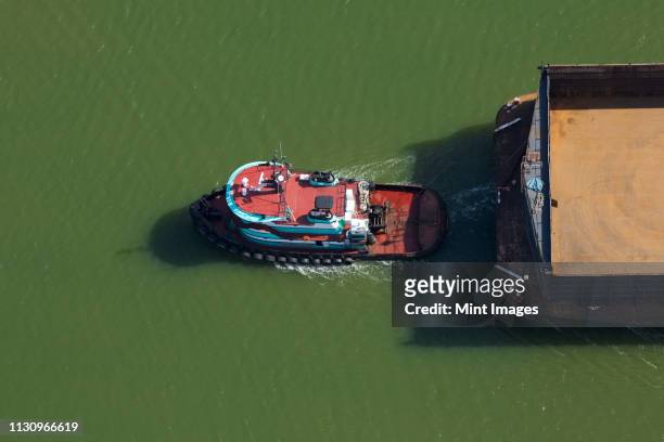 tugboat pulling barge - tug barge stock pictures, royalty-free photos & images