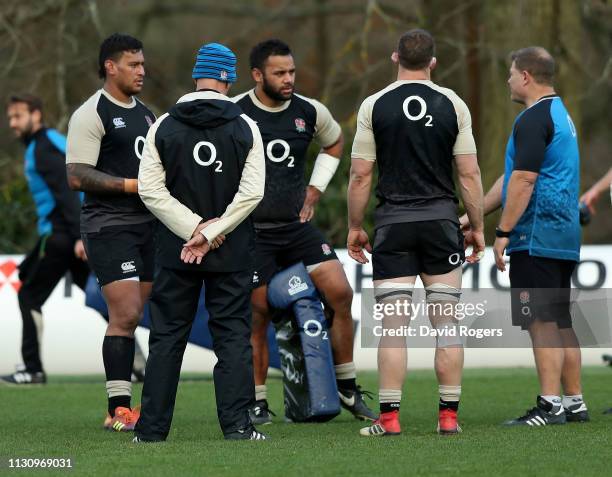 Neal Hatley, the scrum coach talks to back row forwards, Billy Vunipola, Mark Wilson and Nathan Hughes during the England training session held at...