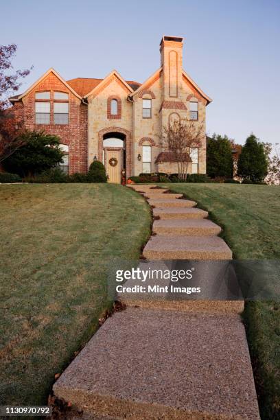 pathway to large home on hillside - texas house stock pictures, royalty-free photos & images