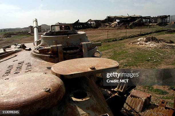 Rusting milary tanks left fom the Iraq-Iran war are scattered across the countryside near Qasr-e-Shirin, Iran, on February 15, 2003. Residents saw...