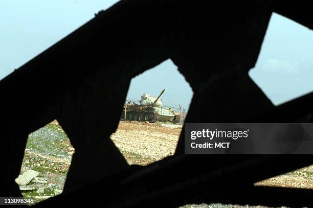Rusting milary tanks left from the Iraq-Iran war are scattered across the countryside near Qasr-e-Shirin, Iran, on February 15, 2003. Residents saw...