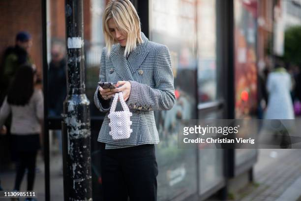 Linda Tol is seen wearing plaid blazer outside Shrimps during London Fashion Week February 2019 on February 19, 2019 in London, England.