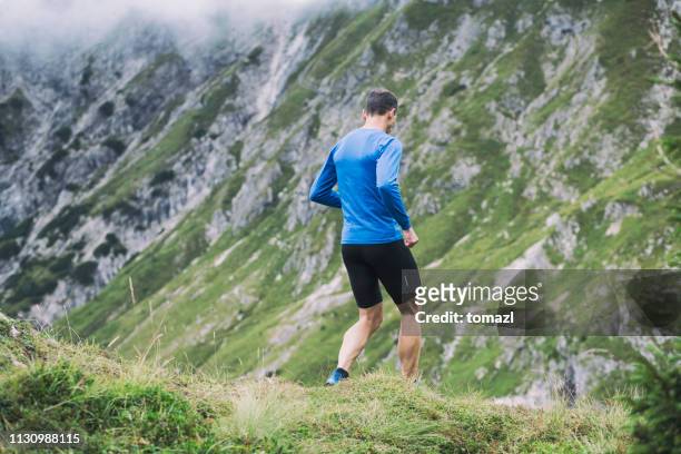 mountain running - shorts down stock pictures, royalty-free photos & images