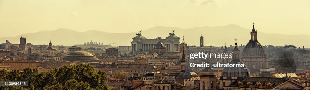 Panoramic skyline of Rome with ancient architecture at sunset