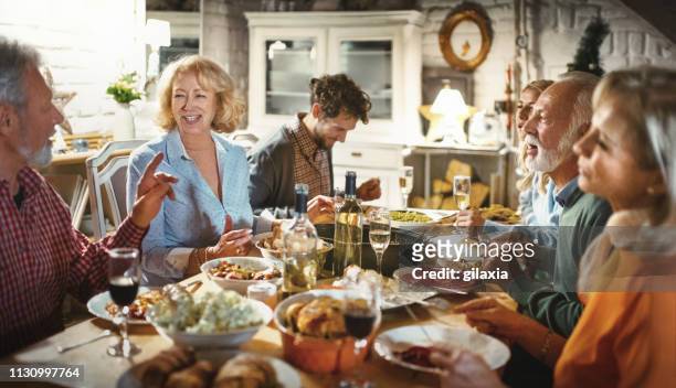 family having a dinner party. - evening meal restaurant stock pictures, royalty-free photos & images