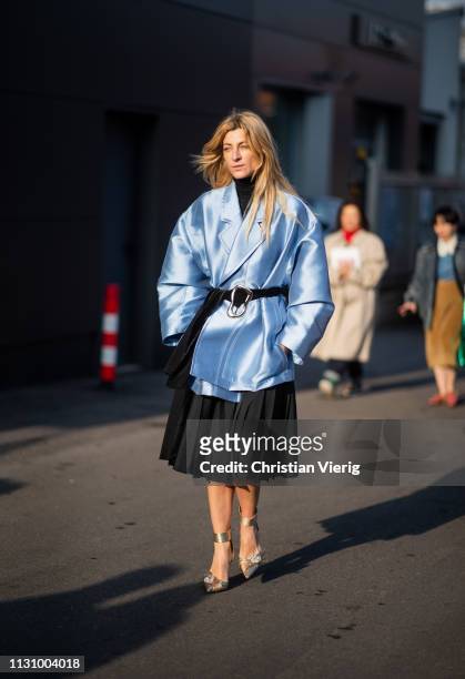 Ada Kokosar is seen wearing blue belted coat, black pleated skirt outside Gucci on Day 1 Milan Fashion Week Autumn/Winter 2019/20 on February 20,...