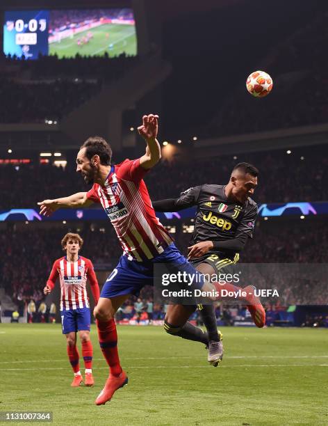 Juanfran of Club Atletico de Madrid challenges Alex Sandro of Juvenus during the UEFA Champions League Round of 16 First Leg match between Club...