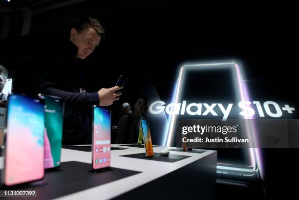 An attendee looks at a display of Samsung Galaxy S10 smartphones during the Samsung Unpacked event on February 20, 2019 in San Francisco, California....