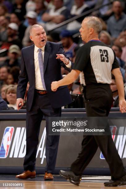 Head coach Michael Malone of the Denver Nuggets disputes a call with Jason Phillips while playing the Houston Rockets at the Pepsi Center on February...