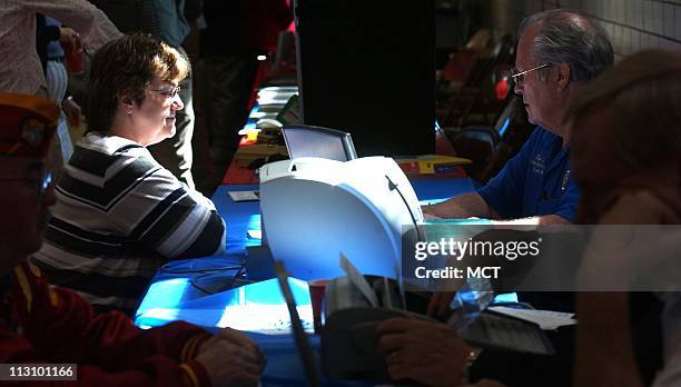 Air Force veteran Janet Etling, left, fills out paperwork with advisor Bud Lane in Jefferson City, Missouri, in April 2004 at an event sponsored by...