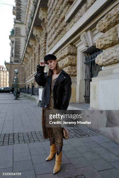 Maike Schmitz wearing Isabel Markant shoes, Leo dress &otherstories, Asos leather jacket, Earrings Pilgrim, Aigner bag on February 18, 2019 in...