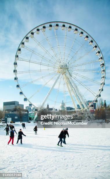 montreal canada people skating under the ferris wheel in old port quarter - montreal imagens e fotografias de stock