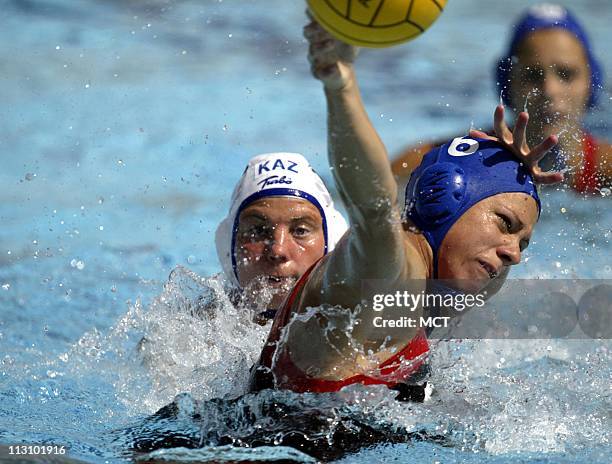 Canada's Ann Dow, left, passes over the defense of Kazakhstan's Marina Gritsenko in a water polo match during the 2004 Olympic Games on Sunday,...