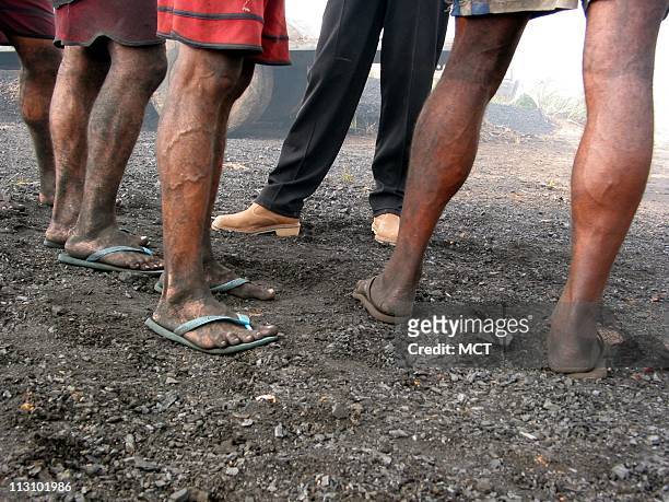 Member of the Brazilian labor ministry's anti-slavery team talks with charcoal workers at a ranch in the state of Maranhao. The ranch supplied...