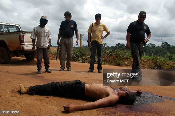 Group of men stare at the fresh corpse of a dead worker a few miles from the Macauba Ranch. There, a Brazilian anti-slavery team freed the man's...